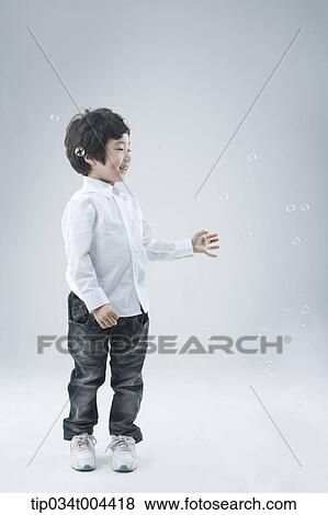 a male kid playing with bubbles View Large Photo Image Stock Photo - a male kid playing with bubbles. Fotosearch