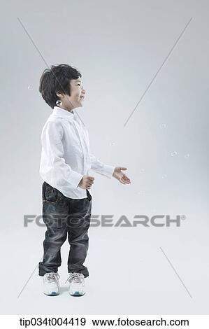 a male kid playing with bubbles View Large Photo Image Stock Photo - a male kid playing with bubbles. Fotosearch