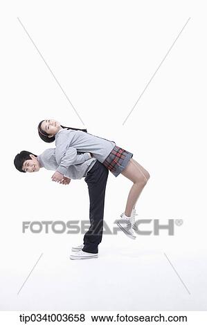 Stock Photo - a male student carrying female student on his back. Fotosearch