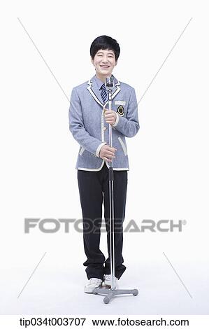 a male student grabbing a microphone stand View Large Photo Image Stock Photo - a male student grabbing a microphone stand . Fotosearch