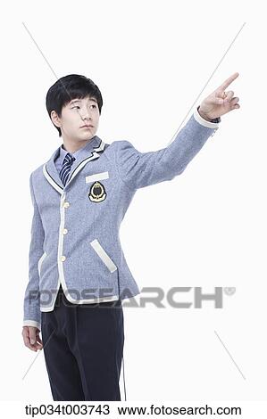 Stock Image - a male student pointing behind . Fotosearch