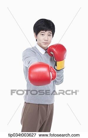 a male student punching with boxing gloves View Large Photo Image Stock Photo - a male student punching with boxing gloves. Fotosearch