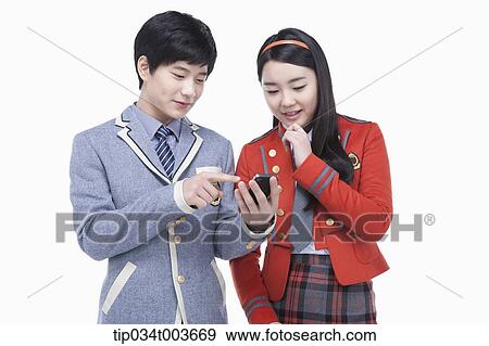 Stock Photo - a male student showing his mobile phone to a female student. Fotosearch