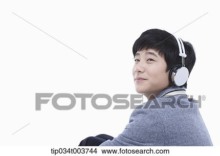 a male student sitting while wearing a headphone View Large Photo Image Picture - a male student sitting while wearing a headphone. Fotosearch