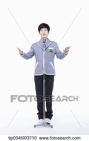 Stock Image - a male student standing with his arms open . Fotosearch