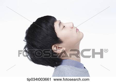Stock Image - a male student stretching his neck. Fotosearch