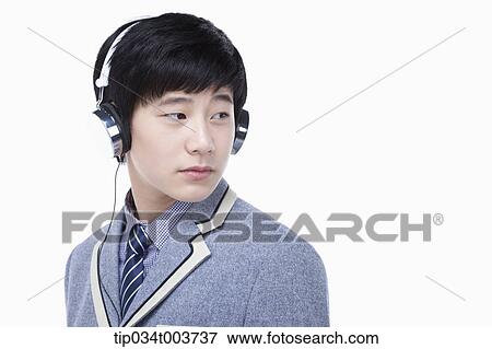 Stock Photo - a male student wearing a headphone. Fotosearch