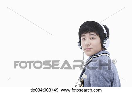 Stock Photo - a male student wearing a headphone facing camera. Fotosearch