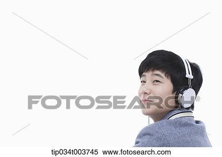 Stock Photography - a male student wearing a headphone. Fotosearch