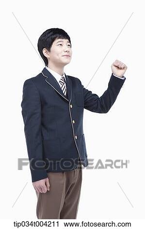 a male student wearing school uniform standing with a fist up View Large Photo Image Stock Image - a male student wearing school uniform standing with a fist up. Fotosearch