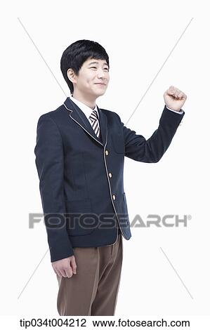 a male student wearing school uniform standing with a fist up View Large Photo Image Stock Image - a male student wearing school uniform standing with a fist up. Fotosearch