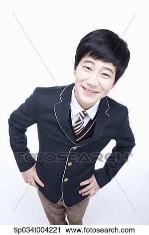 Stock Image - a male student wearing school uniform looking up under camera . Fotosearch