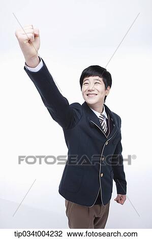 a male student wearing school uniform standing with a fist up View Large Photo Image Stock Image - a male student wearing school uniform standing with a fist up. Fotosearch
