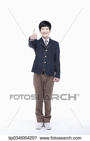 a male student wearing school uniform standing with thumbs up View Large Photo Image Stock Photo - a male student wearing school uniform standing with thumbs up. Fotosearch