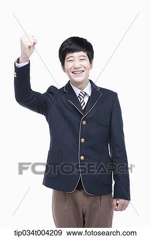 a male student wearing school uniform standing with a fist up View Large Photo Image Stock Photo - a male student wearing school uniform standing with a fist up. Fotosearch