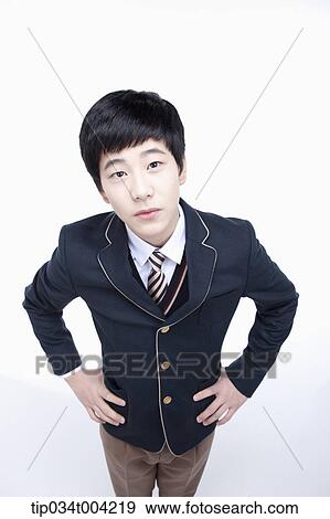 Stock Photo - a male student wearing school uniform looking up under camera . Fotosearch