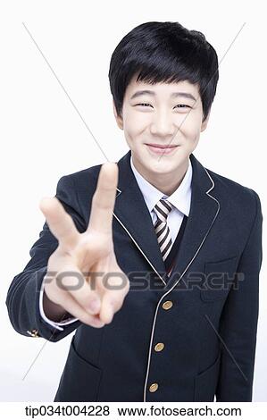 a male student wearing school uniform showing v sign View Large Photo Image Stock Photo - a male student wearing school uniform showing v sign . Fotosearch