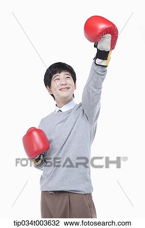 a male student with boxing gloves raising his arm up View Large Photo Image Stock Image - a male student with boxing gloves raising his arm up. Fotosearch