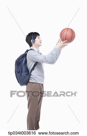 a male student with headphones catching a basketball View Large Photo Image Stock Photograph - a male student with headphones catching a basketball. Fotosearch