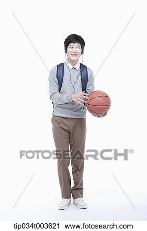 a male student with headphones playing with a basketball View Large Photo Image Stock Image - a male student with headphones playing with a basketball . Fotosearch