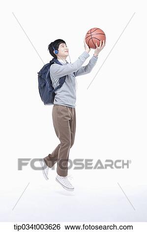 a male student with headphones shooting a basketball View Large Photo Image Stock Photograph - a male student with headphones shooting a basketball. Fotosearch