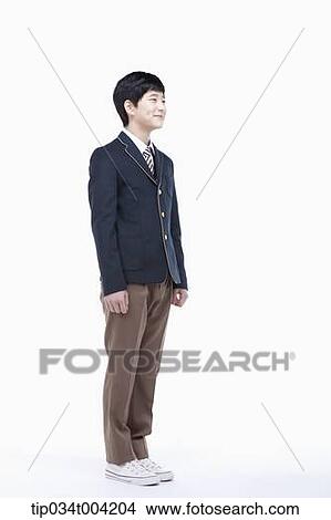 a male student with school uniform standing up straight View Large Photo Image Picture - a male student with school uniform standing up straight. Fotosearch