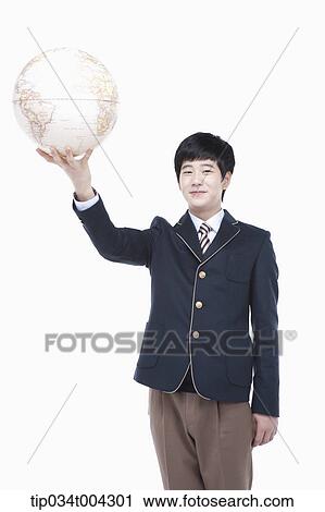 a male student with school uniform holding a globe with one hand View Large Photo Image Stock Image - a male student with school uniform holding a globe with one hand . Fotosearch