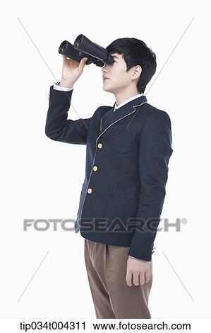 a male student with school uniform looking through a binocular View Large Photo Image Stock Image - a male student with school uniform looking through a binocular. Fotosearch