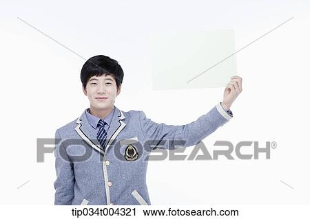 a male student with school uniform holding an empty white paper with one hand View Large Photo Image Stock Image - a male student with school uniform holding an empty white paper with one hand. Fotosearch