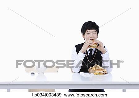 a male student with school uniform eating burgers View Large Photo Image Stock Photo - a male student with school uniform eating burgers. Fotosearch