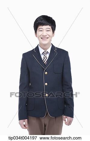 Stock Photo - a male student with school uniform smiling while standing up straight. Fotosearch