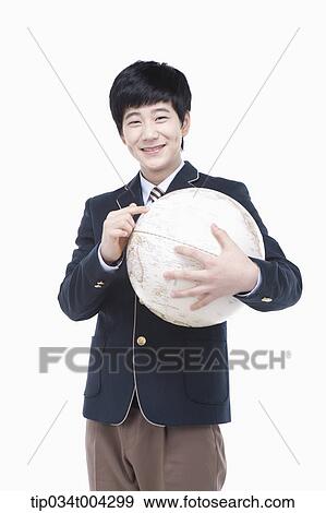 Stock Photo - a male student with school uniform holding a globe. Fotosearch