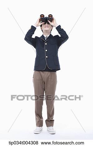 Stock Photo - a male student with school uniform looking through a binocular. Fotosearch