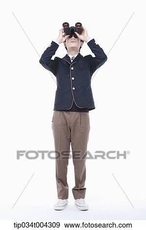 a male student with school uniform looking through a binocular View Large Photo Image Stock Photo - a male student with school uniform looking through a binocular. Fotosearch