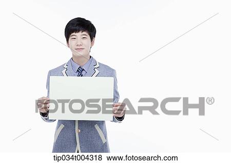 Stock Photo - a male student with school uniform holding an empty white paper . Fotosearch