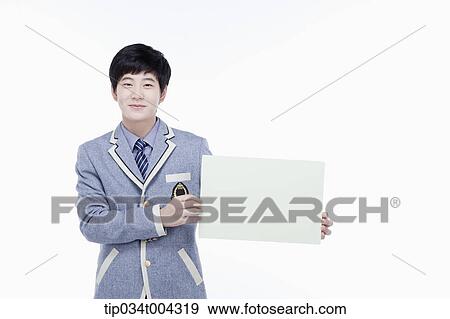 Stock Photo - a male student with school uniform holding an empty white paper . Fotosearch