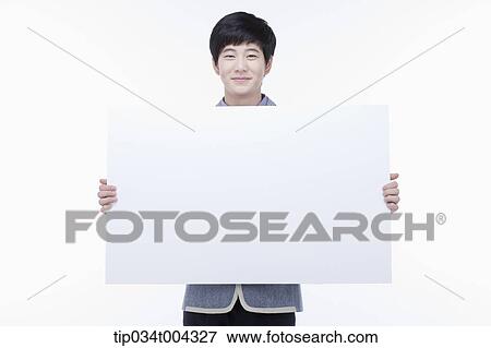 Stock Photo - a male student with school uniform holding a big empty white paper . Fotosearch