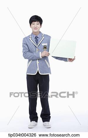 a male student with school uniform holding a empty paper View Large Photo Image Stock Photograph - a male student with school uniform holding a empty paper . Fotosearch