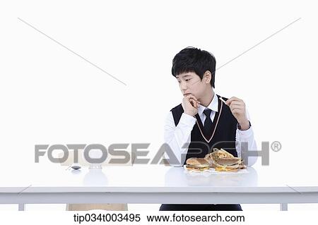 a male student with school uniform staring at burgers while having French fries View Large Photo Image Stock Photography - a male student with school uniform staring at burgers while having French fries . Fotosearch