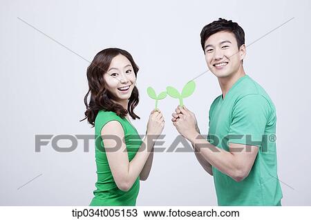 a man and a woman holding big sprouts with their body facing each other View Large Photo Image Stock Image - a man and a woman holding big sprouts with their body facing each other. Fotosearch