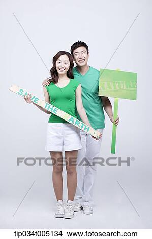 a man and a woman holding signboards saying environmentally friendly phrases View Large Photo Image Picture - a man and a woman holding signboards saying environmentally friendly phrases. Fotosearch