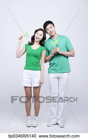 Stock Image - a man and a woman holding sprouts. Fotosearch