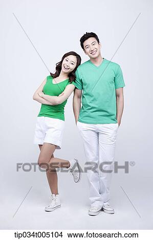 Picture - a man and a woman in green t-shirt posing . Fotosearch