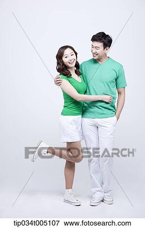 a man and a woman in green t-shirt posing in each other's arm View Large Photo Image Stock Photo - a man and a woman in green t-shirt posing in each other's arm. Fotosearch