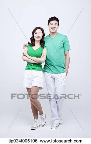 a man and a woman in green t-shirt posing View Large Photo Image Stock Photograph - a man and a woman in green t-shirt posing . Fotosearch