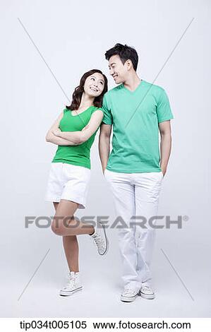 Stock Photography - a man and a woman in green t-shirt posing . Fotosearch