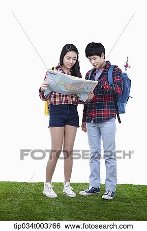 Stock Photograph - a man and a woman looking at map together. Fotosearch