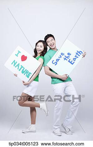 a man and a woman posing holding signboards with environmentally friendly phrases View Large Photo Image Stock Image - a man and a woman posing holding signboards with environmentally friendly phrases. Fotosearch