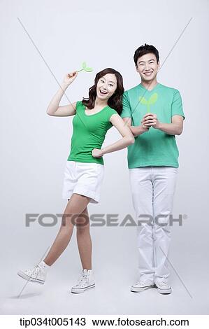 a man and a woman posing while holding sprouts View Large Photo Image Stock Image - a man and a woman posing while holding sprouts. Fotosearch