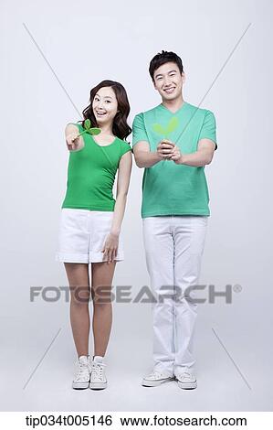 Stock Photograph - a man and a woman posing with sprouts . Fotosearch